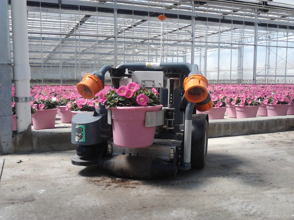 Automated Robots move potted plants. 
